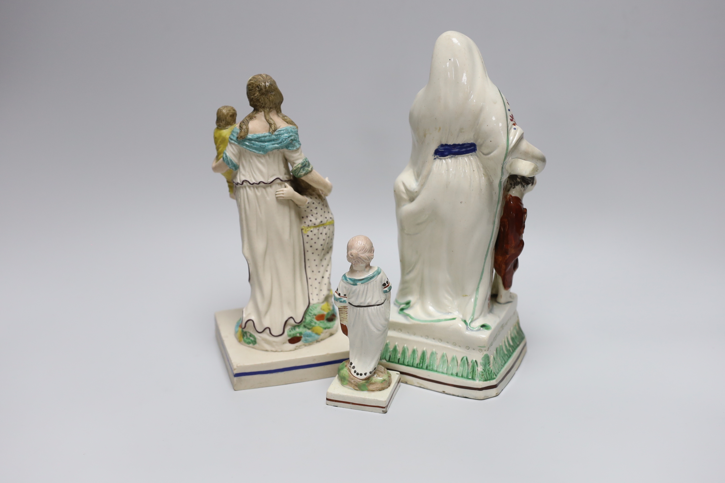 An early 19th century Staffordshire tinted biscuit stoneware figure of a mother with children, emblematic of 